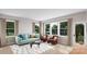 Cozy living room with large windows, comfortable seating, and ample natural light at 7940 Cedarsmith Ct, Charlotte, NC 28217