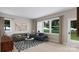 Bright living room with two sofas, coffee table, and large windows at 7940 Cedarsmith Ct, Charlotte, NC 28217
