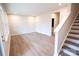 Open-concept living room boasts hardwood floors and staircase access at 7940 Cedarsmith Ct, Charlotte, NC 28217
