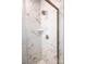 Modern shower with marble-patterned tile, built-in shelf, and sleek fixtures at 7940 Cedarsmith Ct, Charlotte, NC 28217