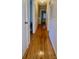 Long hallway with hardwood floors and white wainscoting at 150 Wilson St, Chester, SC 29706