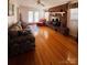 Bright living room features hardwood floors, a brick fireplace, and ample natural light at 150 Wilson St, Chester, SC 29706