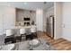 Modern eat-in kitchen with stainless steel appliances, gray cabinets, and a breakfast bar at 1602 Village Grove Ln, Monroe, NC 28110
