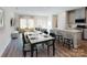 Bright open-plan living/dining area with hardwood floors and modern decor flowing to kitchen at 1602 Village Grove Ln, Monroe, NC 28110