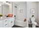 Bathroom with white cabinets, granite counters, shower over tub, and dark hardware at 2411 Datsun Ave, Concord, NC 28027