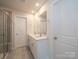 Modern bathroom boasts dual sinks, a glass shower, vinyl flooring, and bright lighting at 849 Blue Canyon Dr, York, SC 29745