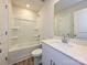 Well-lit bathroom features a shower-tub combo, single sink with quartz countertop, and wood-look vinyl flooring at 849 Blue Canyon Dr, York, SC 29745