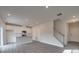 Open living space showcasing hardwood floors, a view of the staircase, and an adjacent kitchen area at 849 Blue Canyon Dr, York, SC 29745