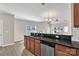 Kitchen with stainless steel appliances, granite counters, tile backsplash, and a view to the backyard at 8505 Loxton Cir, Charlotte, NC 28214