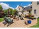 Outdoor living space boasts a fire pit, hot tub, and grilling area with backyard views at 9618 Belloak Ln, Waxhaw, NC 28173