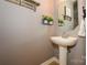 A charming half bathroom featuring a pedestal sink and decorative accents at 9618 Belloak Ln, Waxhaw, NC 28173