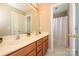Bathroom boasting double sinks, wood cabinets and a separate shower area at 9618 Belloak Ln, Waxhaw, NC 28173