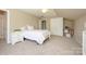 Bright bedroom featuring neutral carpet, a bed, and a closet on the far wall at 9618 Belloak Ln, Waxhaw, NC 28173