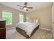 Cozy bedroom with a ceiling fan and two windows for natural light at 9618 Belloak Ln, Waxhaw, NC 28173