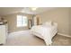 Cozy bedroom featuring a bright window, neutral tones, and plush carpeting at 9618 Belloak Ln, Waxhaw, NC 28173