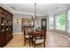Elegant dining room with hardwood floors, modern chandelier, and views into an open space at 9618 Belloak Ln, Waxhaw, NC 28173