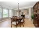 Bright dining room with hardwood floors, crown molding, and multiple windows for natural light at 9618 Belloak Ln, Waxhaw, NC 28173