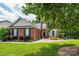 Beautiful brick home with black shutters, pristine landscaping, and a well-maintained lawn at 9618 Belloak Ln, Waxhaw, NC 28173