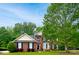 Charming brick two-story home with manicured lawn and lush landscaping showcasing curb appeal at 9618 Belloak Ln, Waxhaw, NC 28173