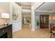 Open-concept foyer with hardwood floors, elegant molding, and view of the living room fireplace at 9618 Belloak Ln, Waxhaw, NC 28173