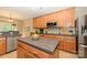 Bright kitchen with a large island, stainless steel appliances, light wood cabinets and stone tile backsplash at 9618 Belloak Ln, Waxhaw, NC 28173