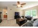 Relaxing living room area with a ceiling fan, cozy furniture, and lots of natural light at 9618 Belloak Ln, Waxhaw, NC 28173
