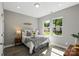 Bright bedroom with two windows, wood floors, and a comfortable bed with decorative pillows at 1105 Kenly St, Salisbury, NC 28144