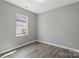 This cozy bedroom has a neutral color palette and wood-look floors at 1105 Kenly St, Salisbury, NC 28144
