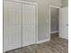 Bedroom closet with white bi-fold doors and wood flooring at 1105 Kenly St, Salisbury, NC 28144