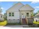Charming new construction home with white siding, brick stairs, and a welcoming covered front porch at 1105 Kenly St, Salisbury, NC 28144