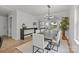 Elegant dining room with hardwood floors and a modern chandelier at 1320 Brook Rd, Charlotte, NC 28205