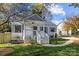 Charming white brick home with gray accents and a landscaped lawn at 1320 Brook Rd, Charlotte, NC 28205