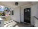 Inviting front porch with white railings and a black front door at 1320 Brook Rd, Charlotte, NC 28205