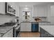 Modern kitchen with white cabinets, granite counters, and a blue dishwasher at 1320 Brook Rd, Charlotte, NC 28205