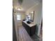 Elegant bathroom featuring a double vanity, modern fixtures, and a well-lit mirror, and wood style laminate flooring at 2100 Temple St, Kannapolis, NC 28081