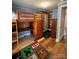 Bright bedroom with a wooden loft bed with desk and storage, adjacent to wood paneled wall feature at 2100 Temple St, Kannapolis, NC 28081