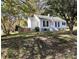 Charming single-story home featuring white siding, a green roof, and a manicured front lawn in a leafy neighborhood at 2100 Temple St, Kannapolis, NC 28081