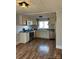 Well-lit kitchen with modern appliances, countertops, and ample cabinet space, with wood style laminate flooring at 2100 Temple St, Kannapolis, NC 28081