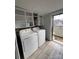 Practical laundry area with overhead cabinets, modern appliances, and convenient access to the exterior at 2100 Temple St, Kannapolis, NC 28081