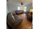 Inviting living room with hardwood floors, three sofas, natural light, and a ceiling fan at 2100 Temple St, Kannapolis, NC 28081