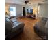 Cozy living room featuring hardwood floors, dual sofas, neutral walls, a TV and ample seating at 2100 Temple St, Kannapolis, NC 28081