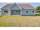 Picture of the back of the home showing covered patio, and lawn at 220 W Lawyers Rd, Monroe, NC 28110