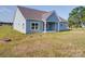 View of the back of the light blue home, with ample green lawn at 220 W Lawyers Rd, Monroe, NC 28110