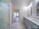 Bathroom view to include glass shower, dual sink vanity, and view to bedroom at 220 W Lawyers Rd, Monroe, NC 28110