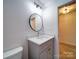 Bathroom featuring a sleek vanity, modern fixtures, and a well-lit mirror at 220 W Lawyers Rd, Monroe, NC 28110