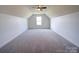 Bedroom with soft carpeting, a ceiling fan and a window providing natural light at 220 W Lawyers Rd, Monroe, NC 28110