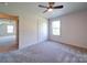 Bedroom featuring ceiling fan, carpet flooring, window and closet at 220 W Lawyers Rd, Monroe, NC 28110