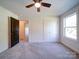 Bedroom featuring ceiling fan, carpet flooring, window and closet at 220 W Lawyers Rd, Monroe, NC 28110