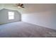 Spacious bedroom featuring soft carpet, a ceiling fan and a window providing natural light at 220 W Lawyers Rd, Monroe, NC 28110