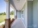 Inviting porch featuring stately brick columns and crisp white trim at 220 W Lawyers Rd, Monroe, NC 28110